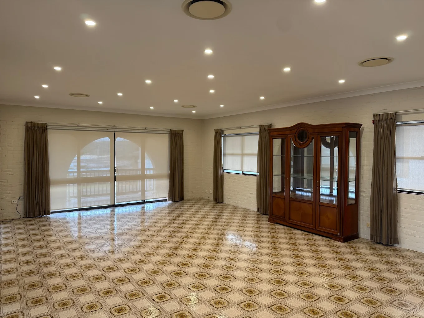 Large empty living area with polished tile floors prepared for inspection