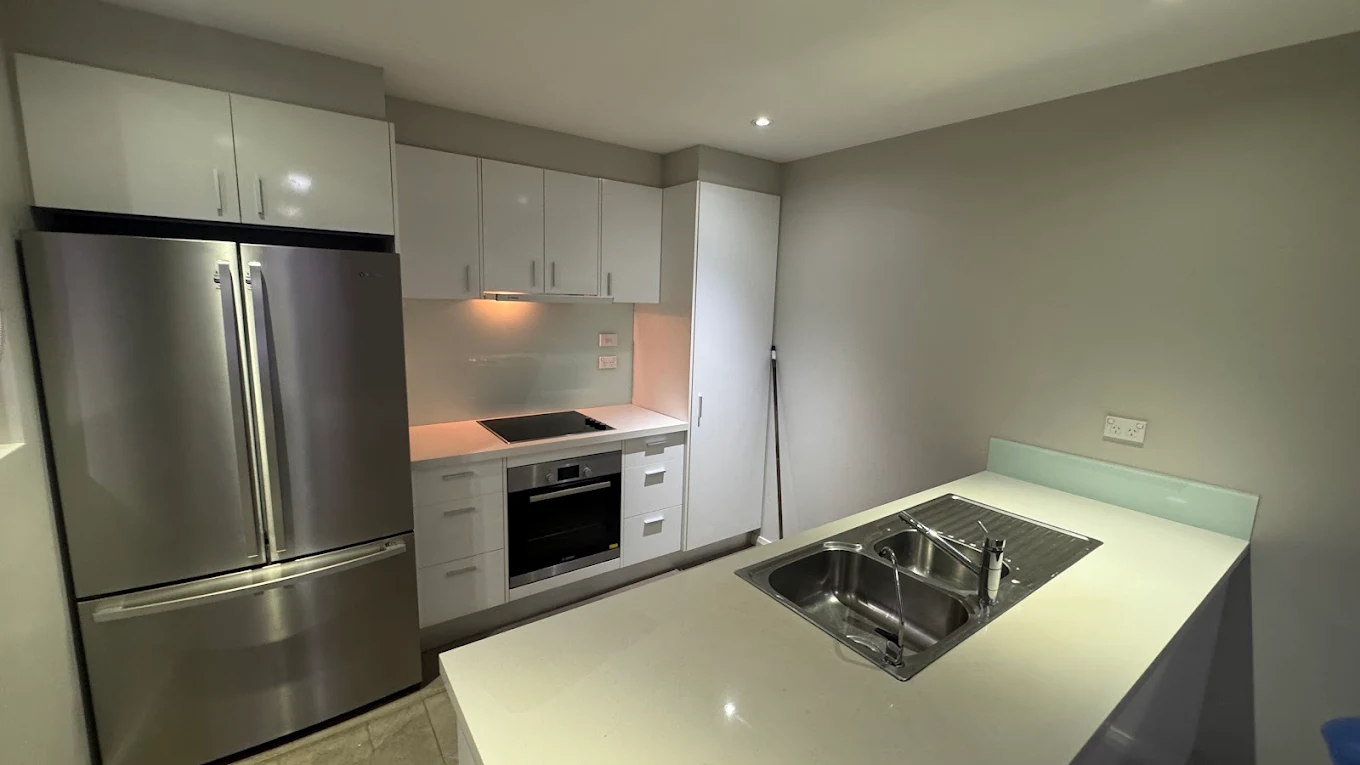 Modern apartment kitchen with stainless appliances cleaned for handover