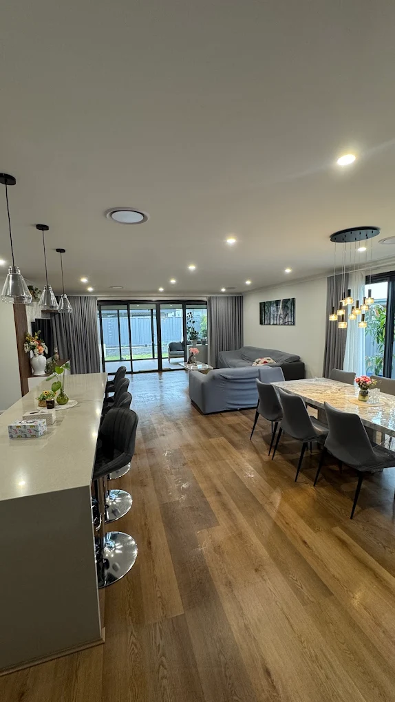 Open plan kitchen, dining and living area cleaned and styled in a modern Illawarra home