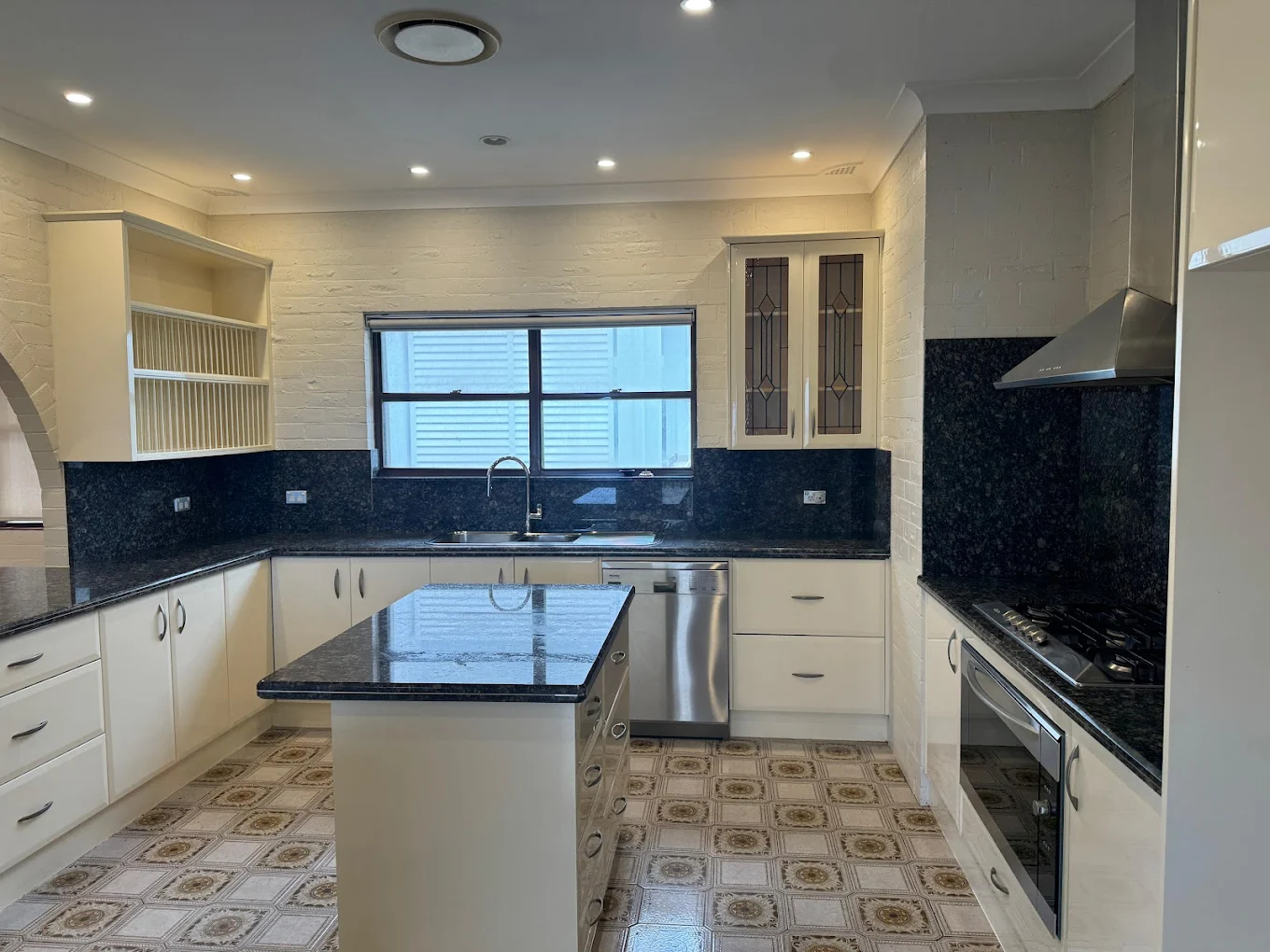 Large kitchen with granite island bench cleaned for end of lease
