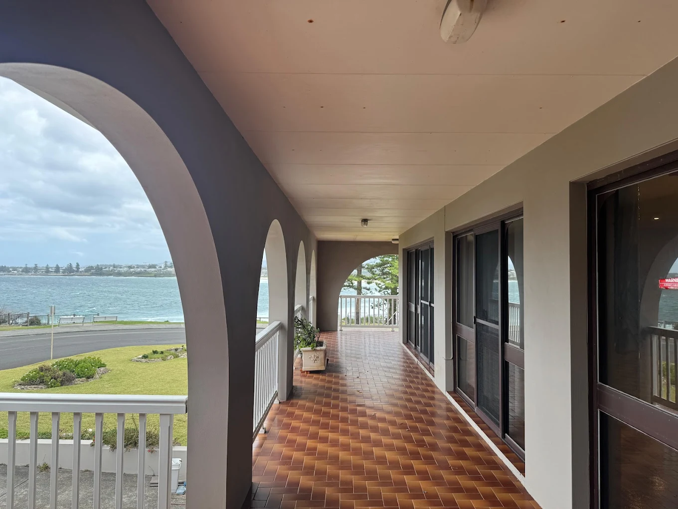 Waterfront balcony with arches and tiled floor cleaned overlooking the ocean