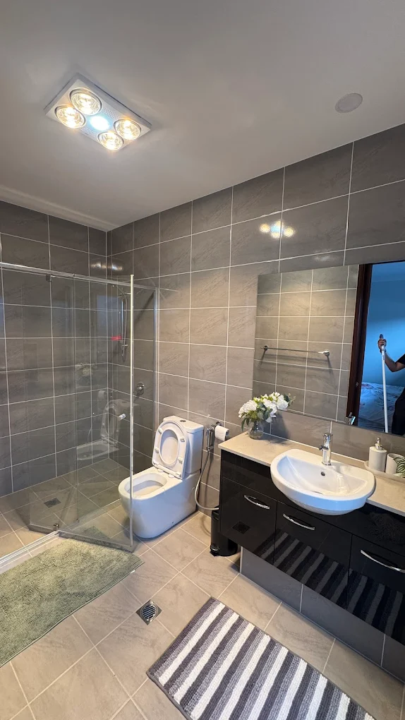 Modern grey-tiled bathroom cleaned by Illawarra Cleaning Crew