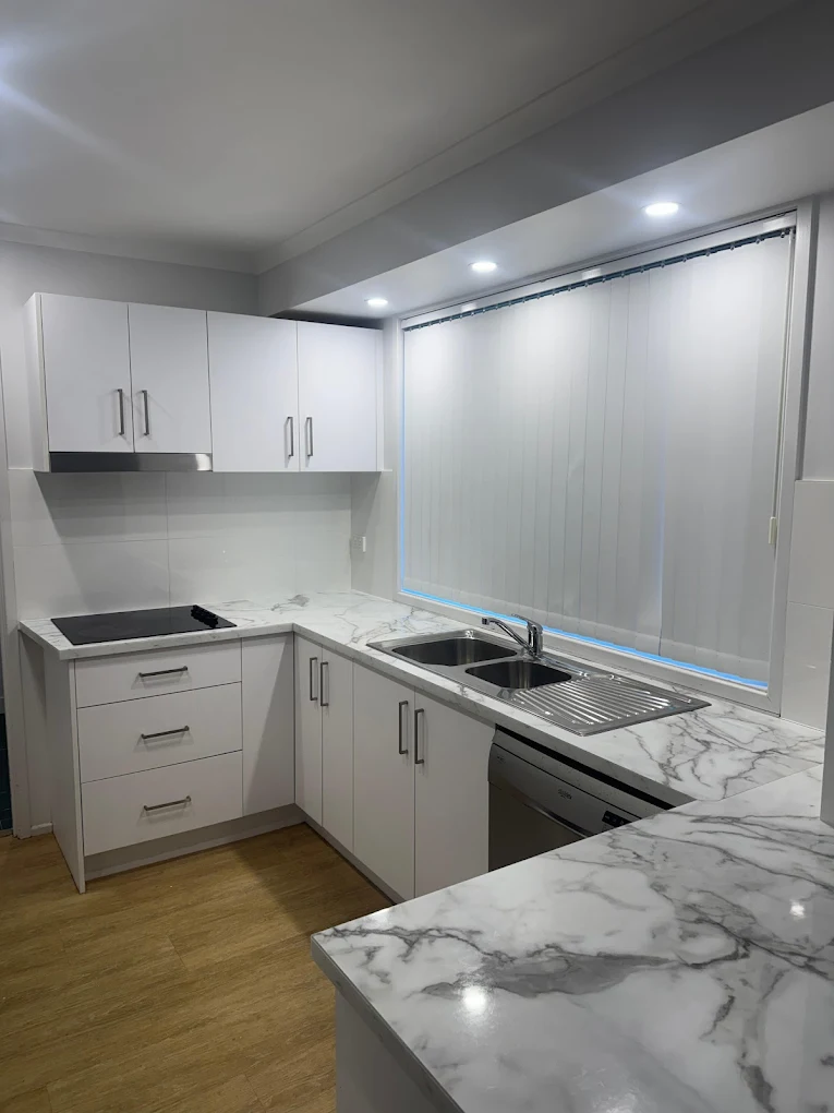 Sparkling white kitchen with marble benchtop after professional clean in Wollongong