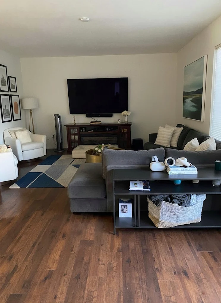 Family lounge room with timber floors and rug after a regular house clean